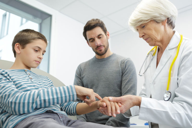 older woman doctor with dad and son